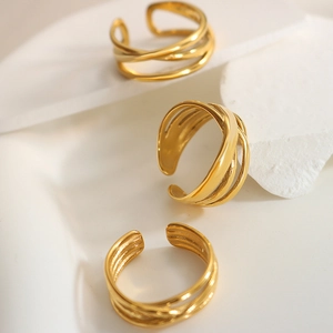 Minimalist gold-plated triple layered cross open ring on white stone display base
