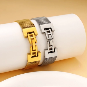 Mesh stretch watch band in gold and silver stainless steel on display pedestals