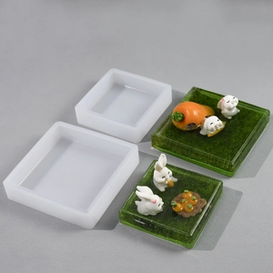 Detail of square silicone mold for DIY resin craft showing rabbit and carrot miniature decor