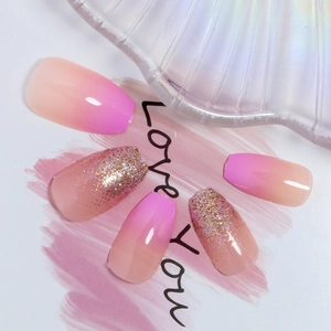 Pink gradient glitter press-on nails in long coffin shape for elegant manicure