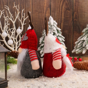 Christmas gnomes with reindeer antler hats and hearts on festive tabletop display