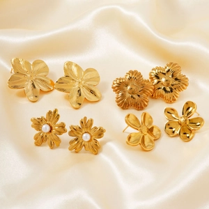Detail of vintage flower geometric earrings with brushed gold and pearl accents