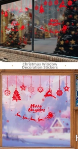 Detail of red Christmas window static stickers showing snowflakes and Santa on glass
