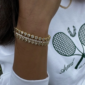 Three-layer gold and silver zircon bracelets with heart and round cuts on female wrist
