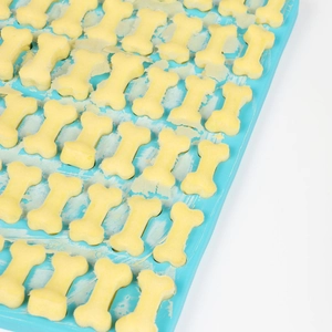 Close-up of blue silicone mold with bone-shaped treats, featuring FDA and temperature marks