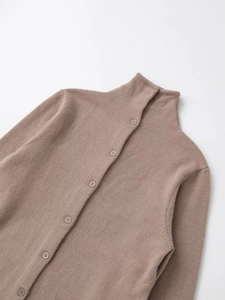 Close-up of mock neck collar and matching buttons on light brown knit cardigan