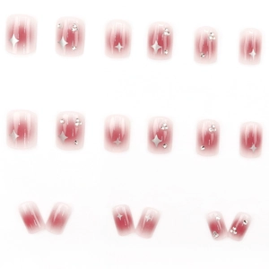 Sweet pink blush gradient press-on nails with silver star prints and crystal rhinestones