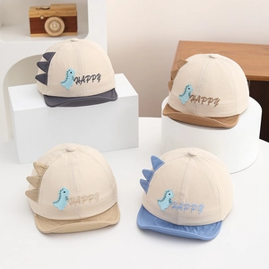Detail showing four colors of breathable dinosaur baby sun hats with happy embroidery
