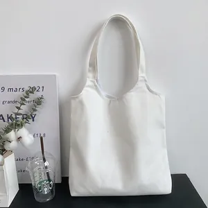 Detailed texture of thick white canvas tote bag with reinforced stitching and blank surface