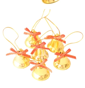 Detailed view of six gold Christmas bells with red bows and hanging strings for tree decoration