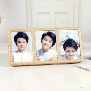 Close-up of a three-panel wooden photo frame featuring rounded corners and natural wood grain