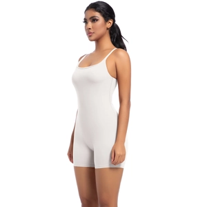 Side view of white slim-fit yoga bodysuit with thin straps and elastic fabric