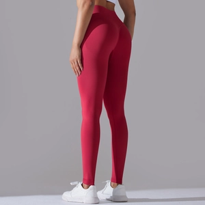 Close-up of deep red seamless knit leggings showing vertical ribbed texture and booty lifting