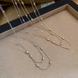 Minimalist layered gold and silver bead necklaces with rice-shaped metal accents