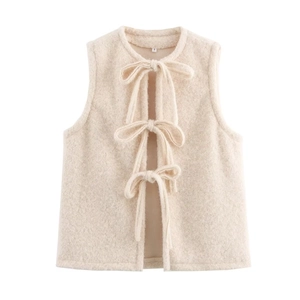 Detail of beige fuzzy vest showing front bow ties and soft texture of the mohair fabric