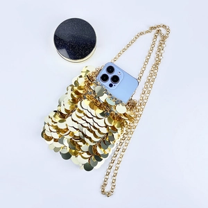 Detailed view of the gold sequin crossbody bag showing capacity for phone and makeup