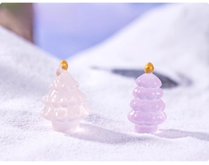 Macro view of mini resin luminous Christmas trees in pink and purple for micro landscapes