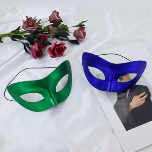 Metallic finish green and blue half-face masquerade masks on white silk background