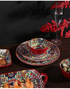 Bohemian ceramic tableware set with vibrant mandala patterns on dark wooden table