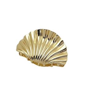 Golden shell hair claw clip in punk style with polished metal scallop texture