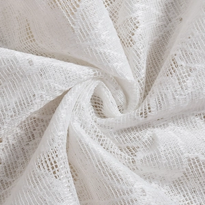 Detail shot of white mesh lace fabric with a textured square pattern and sheer finish