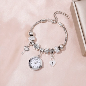 Silver beaded bracelet watch with heart, key and lock charms on pink silk background