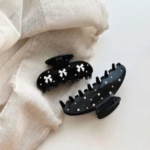 Minimalist black rhinestone water drop hair claw set with white bow accents