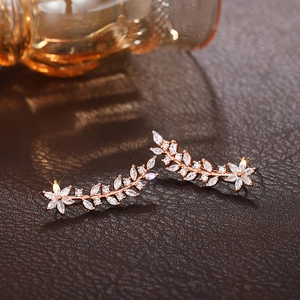 Detail of rose gold flower ear crawler earrings with marquise cut sparkling crystals