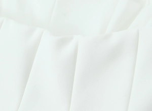 Close-up of white tube top fabric texture with premium woven detail and structured feel