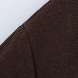 Close-up of the textured brown wool fabric and detailed stitching on a winter coat