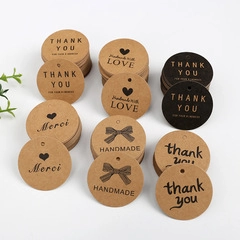 Macro shot of assorted brown kraft paper thank you gift tags on a clean white background