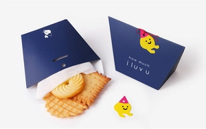 Detail of dark blue gift box with yellow cartoon charm and assorted cookies inside