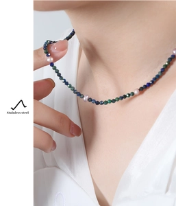 Detail of multi-color lapis beads and pink freshwater pearls on a stainless steel necklace
