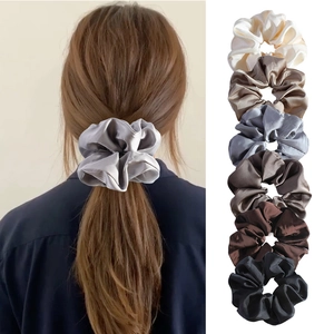 Set of 6 premium silk satin scrunchies in neutral tones shown on hair and stacked