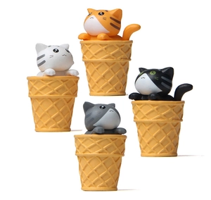 Detail of four colorful cat figurines inside waffle cones for micro landscape garden decor