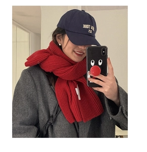 Close-up of red chunky knit scarf with ribbed texture for winter fashion styles