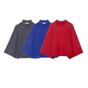 Oversized poncho knit sweater in dark grey, klein blue, and red with half-high collar
