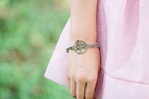 Detailed close-up of a silver Tree of Life pendant on a double-layer stainless steel chain