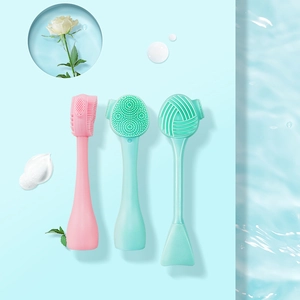 Three silicone facial cleansing brushes in pink, blue, and green for skincare and makeup routines
