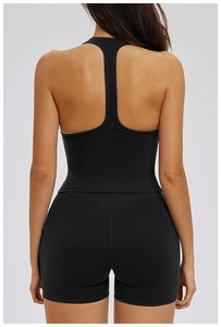 Rear view of black T-back sports bra and high-waist shorts showing back muscle definition