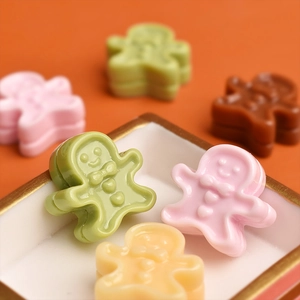 Macro shot of miniature resin gingerbread man figurines for DIY crafts and dollhouse decor