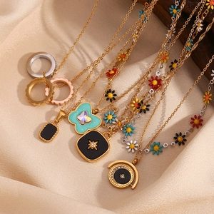 Chic 18K gold plated heart shell pendant necklace set with enamel rings on silk background