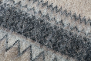 Macro detail of thick zigzag knit fabric with brushed texture in camel and grey