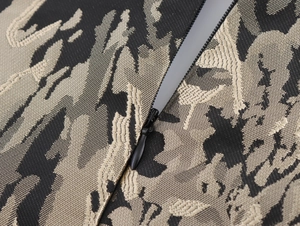 Macro shot of jacquard fabric texture and black invisible zipper on the dress back