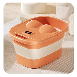 Close-up of orange folding foot bath bucket with integrated digital temperature display