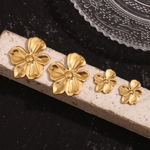 Macro detail of 18K gold plated stainless steel flower earrings in two sizes