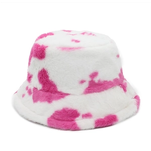 Close-up of soft pink and white cow print faux fur bucket hat with plush texture