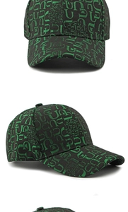 Detail view of black baseball cap with all-over green letter logo print and structured fit