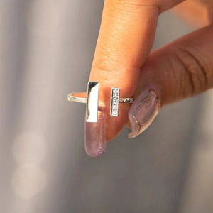 Close-up of a silver square open ring featuring a zircon inlay and polished geometric finish