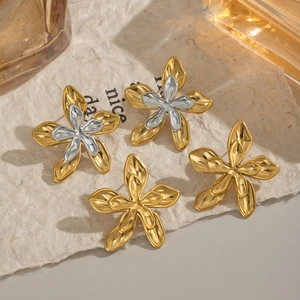 Detailed close-up of mixed gold and silver 18K stainless steel floral stud earrings